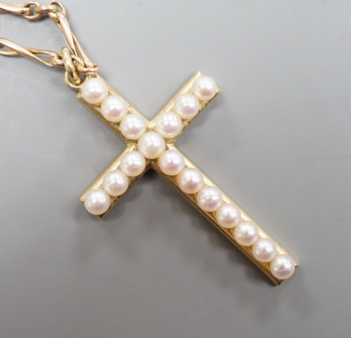 A Mikimoto 14k yellow metal and cultured pearl cluster set cross pendant, 35mm, on an associated yellow metal chain, gross weight 8.7 grams.
